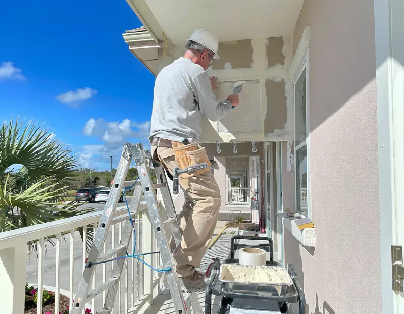 Drywall repair on a two-story Florida apartment and condominium building
